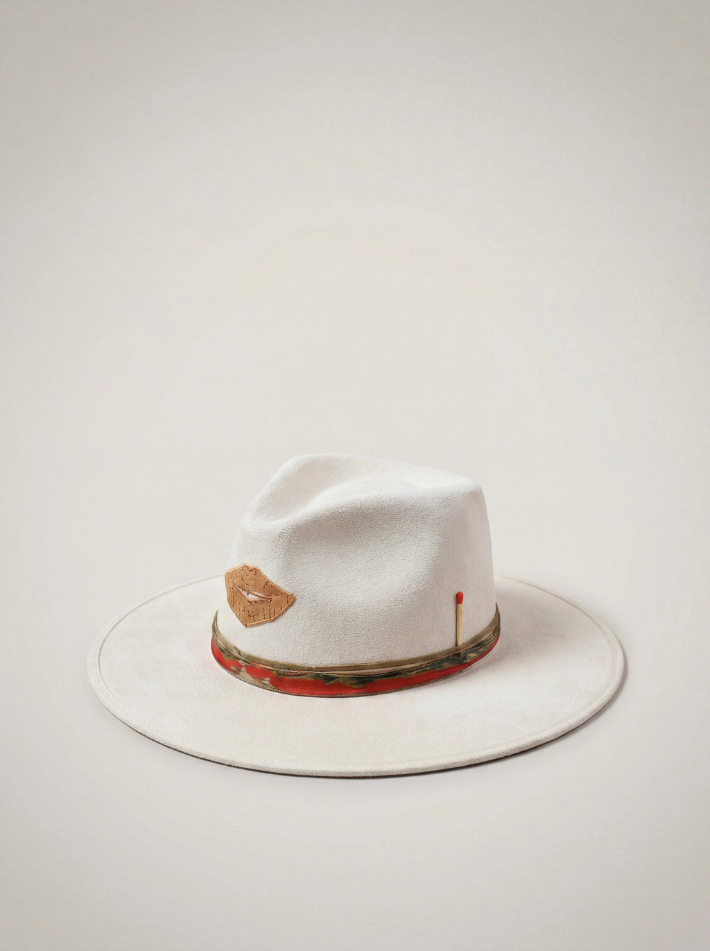 White fedora hat with decorative band on a light gray background