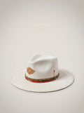 White fedora hat with decorative band on a light gray background