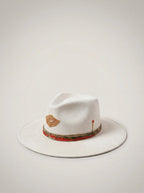 White fedora hat with decorative band on a light gray background