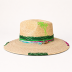 Front view of the natural straw fedora displayed on a stand with green and pink decorative accents.