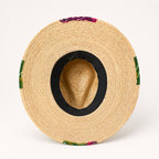 Interior view showing the dark inner head opening and woven underside of the straw hat.