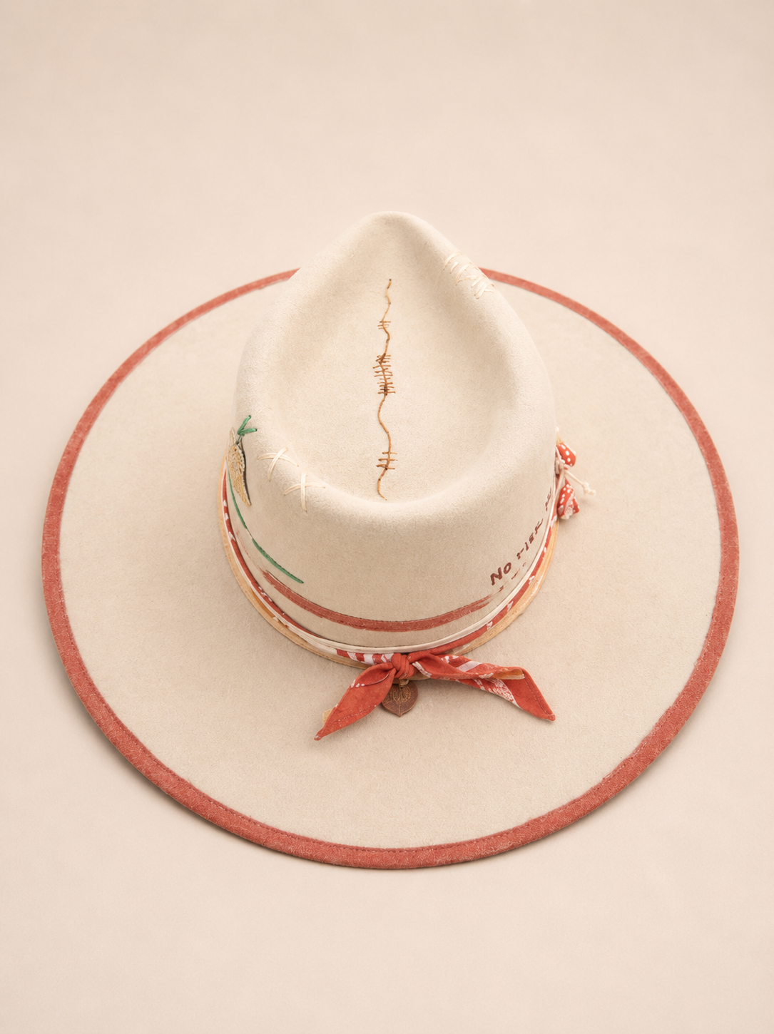Top view of one-of-a-kind hand-painted luxury fedora with embroidered crown detailing