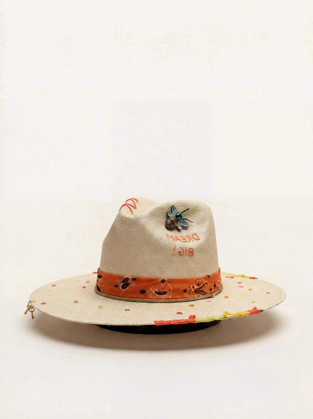 Decorative hat with colorful band and text on a white background