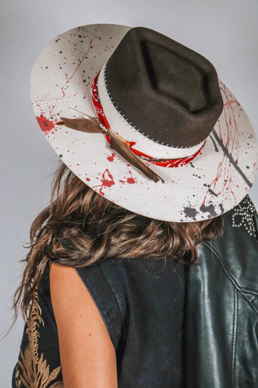 One-of-a-kind bespoke artisan western hat with a chocolate crown and cream brim, highlighting unique red and grey vertical paint drips.