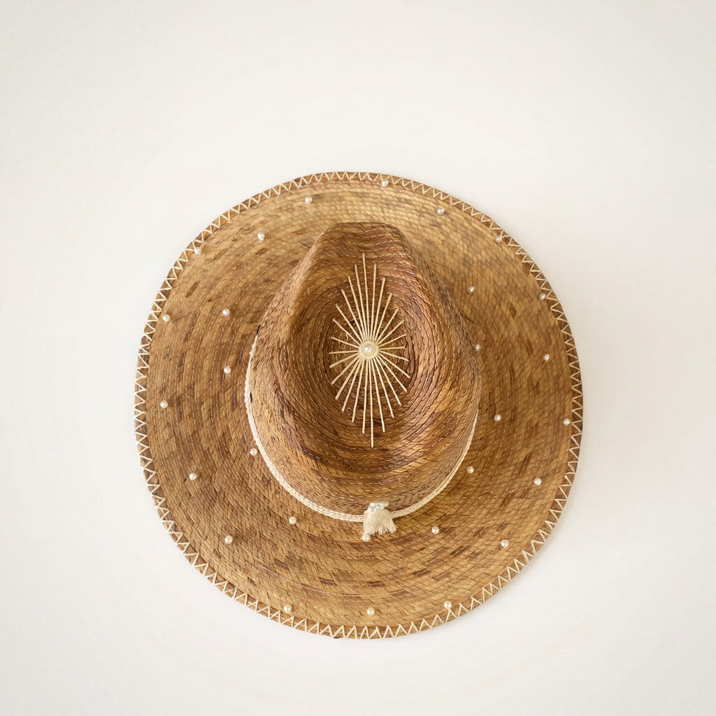 Luxury Pearl Straw Hat Pearl Weaver – Overhead view showing full brim and starburst crown detail