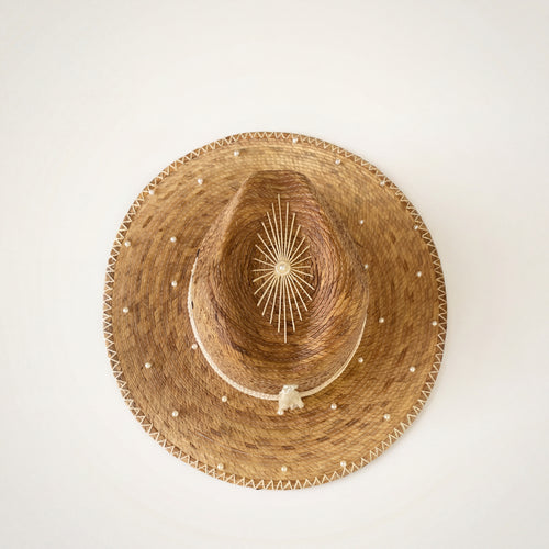 Luxury Pearl Straw Hat Pearl Weaver – Overhead view showing full brim and starburst crown detail